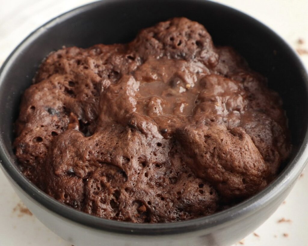 Warm chocolate mug cake after cooking in the microwave 