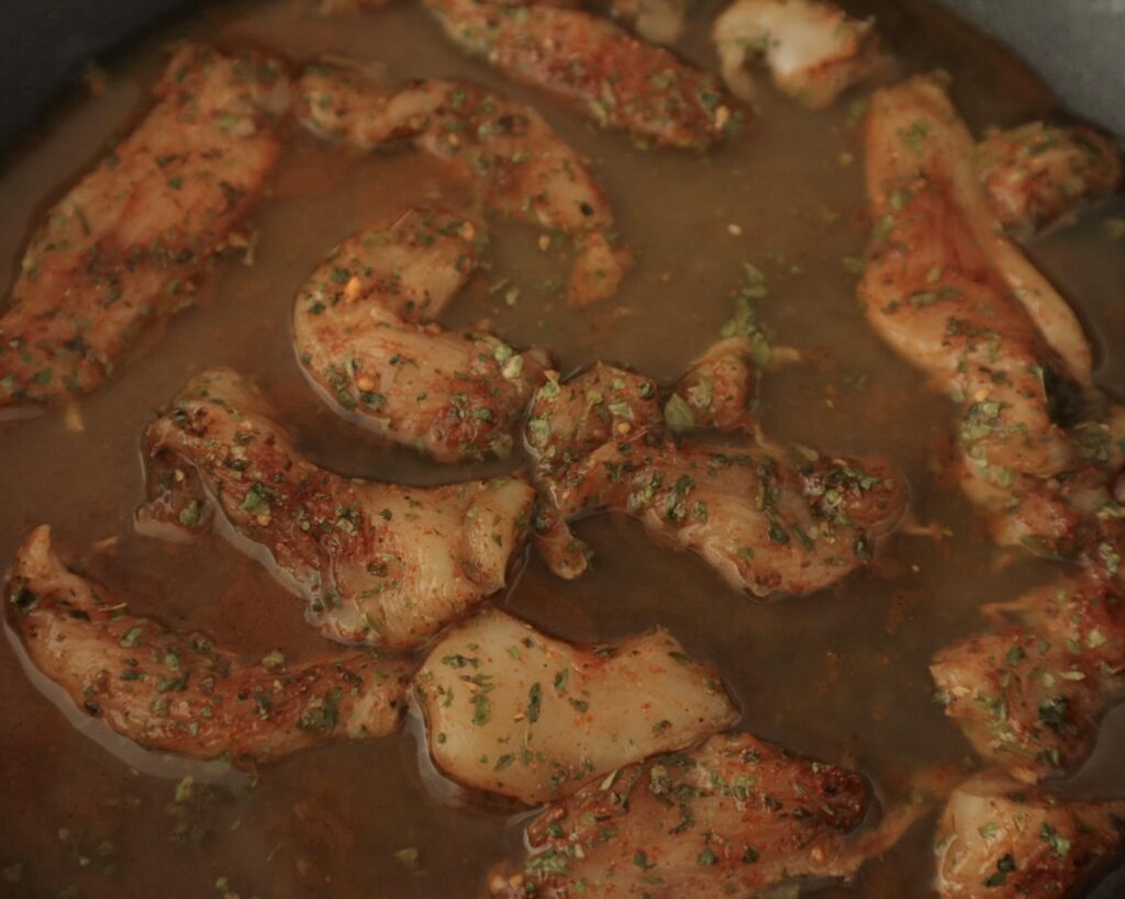 Thinly sliced chicken breast and water added to flavorful korma paste