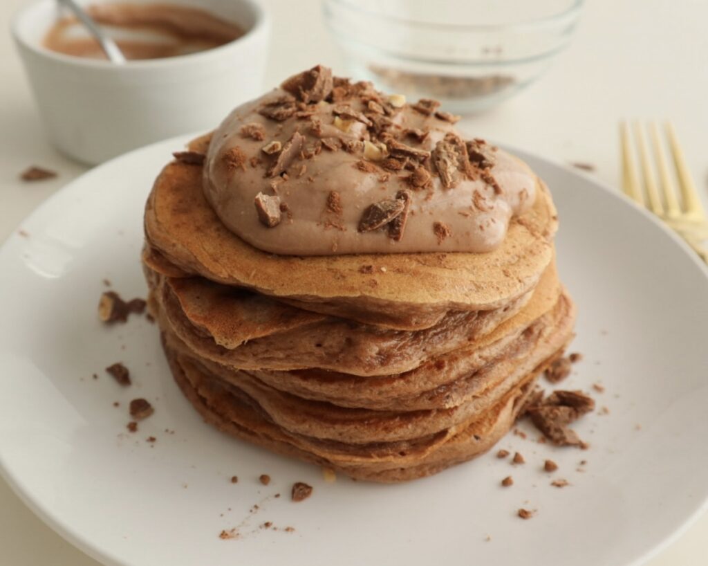 chocolate protein pancakes topped with yoghurt and chopped chcolate