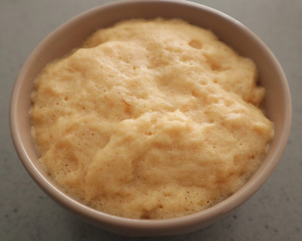 Protein mug cake after being microwaved for 60 seconds